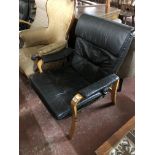 A black leather beech framed relaxer chair