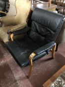A black leather beech framed relaxer chair
