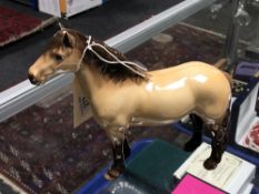 A Beswick Highland Pony in tan glaze.