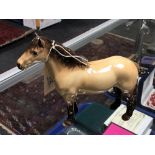 A Beswick Highland Pony in tan glaze.