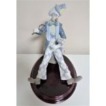 A Lladro figure of a clown with magnifying glass on plinth CONDITION REPORT: Top of