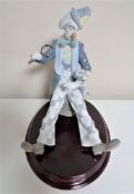 A Lladro figure of a clown with magnifying glass on plinth CONDITION REPORT: Top of