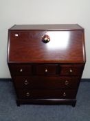 A Stag writing bureau fitted with five drawers