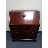 A Stag writing bureau fitted with five drawers