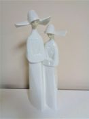 A Lladro figure of two nuns.