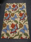 A chain stitched rug with flowers and butterflies 130 cm x 86 cm