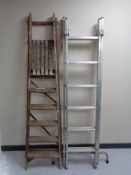 A pair of vintage wooden folding steps and metal twin section ladder