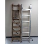 A pair of vintage wooden folding steps and metal twin section ladder