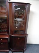 A Stag glazed corner cabinet