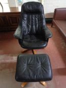 A black leather swivel chair and footstool