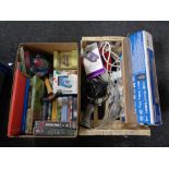A box of household sundries including extension leads, portable sanitizer, books, video tapes,