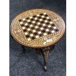 A circular inlaid hardwood occasional table on elephant leg supports CONDITION REPORT: