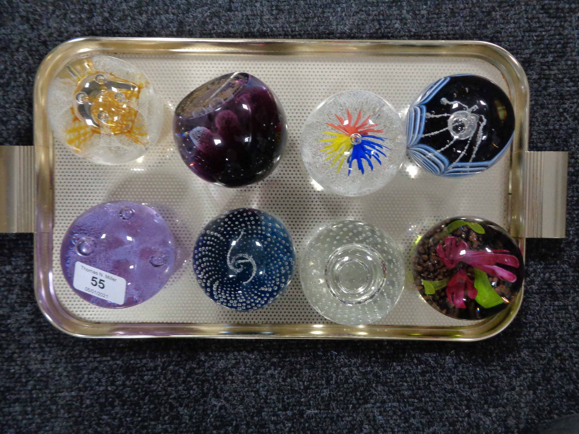 A collection of eight Caithness paperweights.