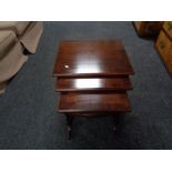 A nest of three mahogany tables