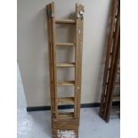 A wooden triple section extension ladder