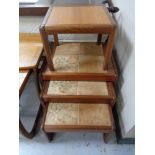 A nest of three twentieth century tiled tables and lamp table