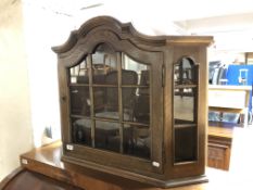 An oak curio wall cabinet