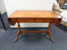 A yewwood flap sided sofa table fitted with two drawers