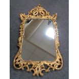 A gilt framed rococo style mirror CONDITION REPORT: This is a 20th century piece.