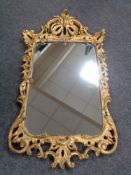 A gilt framed rococo style mirror CONDITION REPORT: This is a 20th century piece.