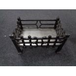 An antique style metal fire grate