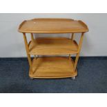 An Ercol Golden Dawn three tier tea trolley CONDITION REPORT: A few minor surface