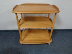 An Ercol Golden Dawn three tier tea trolley CONDITION REPORT: A few minor surface