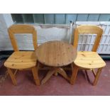 A twentieth century pine occasional table and two chairs