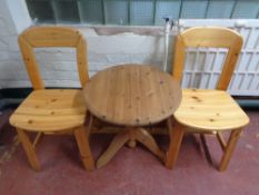 A twentieth century pine occasional table and two chairs