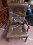 A mid century brown leather armchair