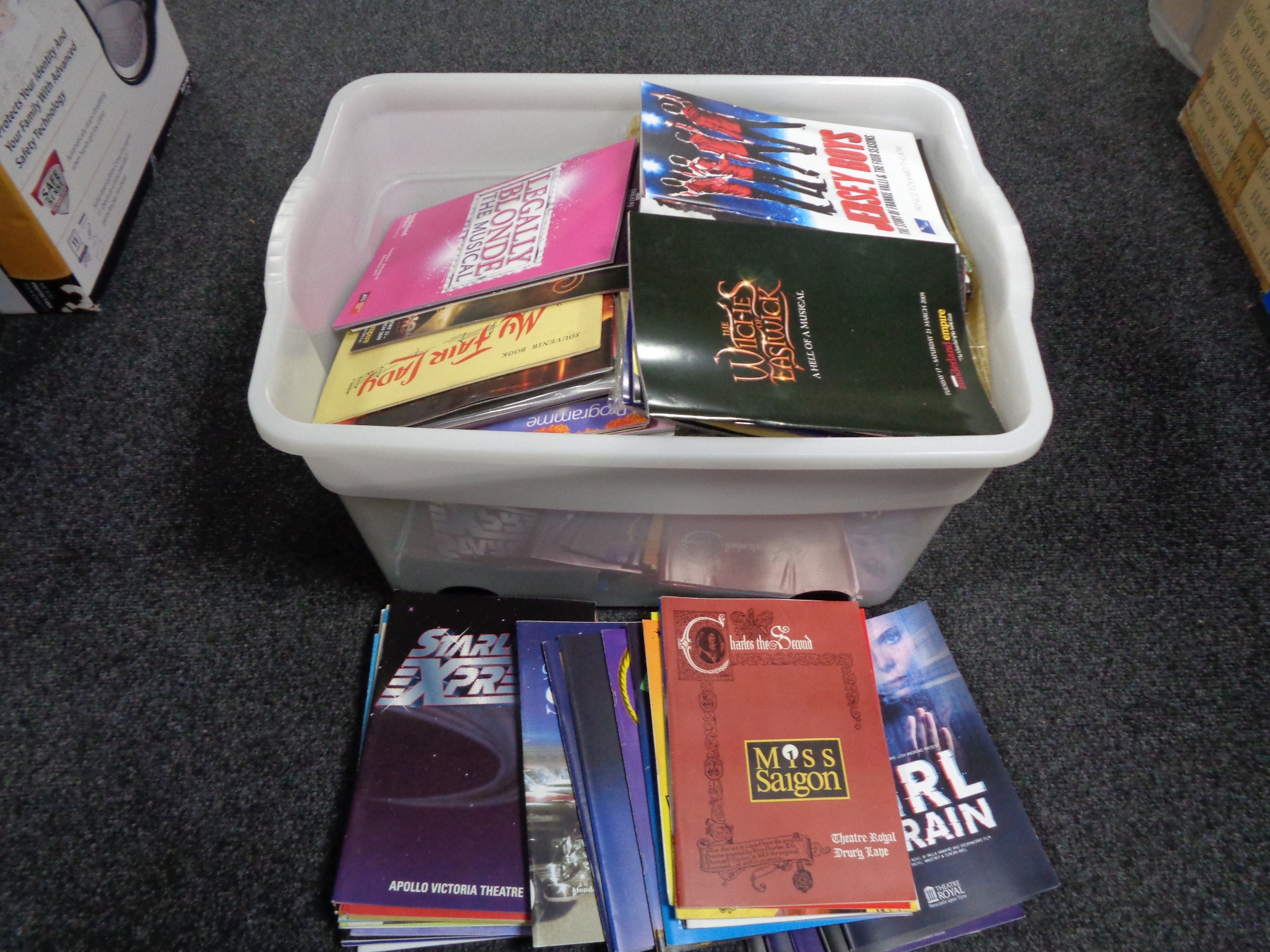 A box of theatre programmes from around the UK