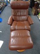 An Ekornes stressless brown leather reclining armchair with footstool