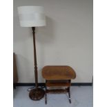 A twentieth century stained beech standard lamp with shade together with two tier occasional table