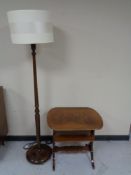 A twentieth century stained beech standard lamp with shade together with two tier occasional table