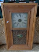 An early twentieth century oak framed wall clock