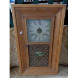 An early twentieth century oak framed wall clock