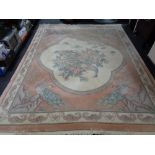 A floral Chinese carpet depicting peacocks on peach ground,