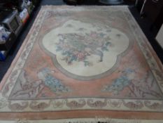 A floral Chinese carpet depicting peacocks on peach ground,