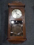 An Edwardian oak wall clock