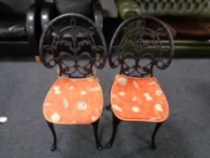A pair of cast metal patio chairs (black)