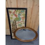 An antique gilt framed oval bevelled mirror together with a framed print depicting a peacock