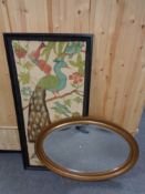 An antique gilt framed oval bevelled mirror together with a framed print depicting a peacock