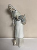 A Lladro figure, lady holding a basket.