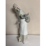 A Lladro figure, lady holding a basket.