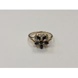 A 10ct gold diamond and sapphire cluster ring, 2.8g, size N/O.