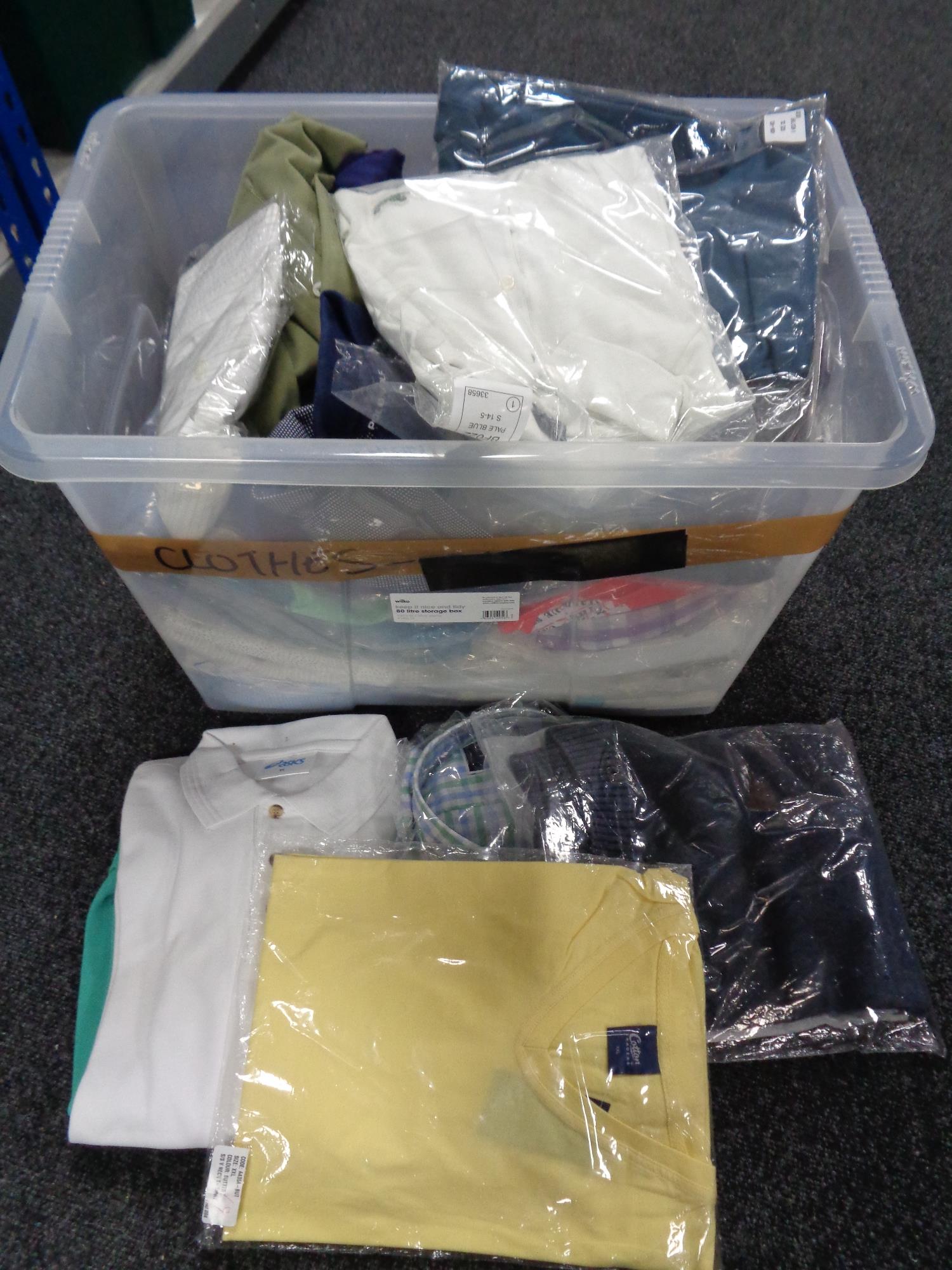 A crate of new and un-used clothing - shirts,