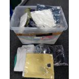 A crate of new and un-used clothing - shirts,