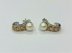 A pair of 14ct white gold pearl and diamond earrings, 4.5g, approximately 0.12ct diamond weight.