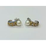 A pair of 14ct white gold pearl and diamond earrings, 4.5g, approximately 0.12ct diamond weight.