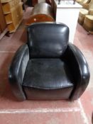 A black leather armchair CONDITION REPORT: 80cm wide by 90cm deep by 79cm high.